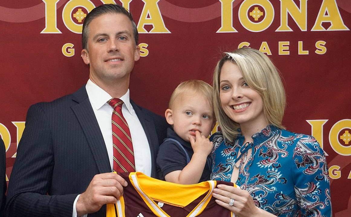 Matt Glovaski with his wife and son holding a Gaels jersey.