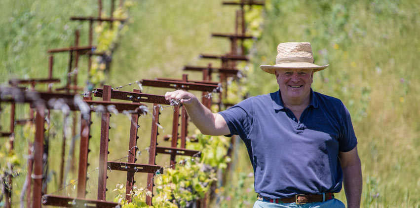 Joe Donelan smiling in his vineyard.
