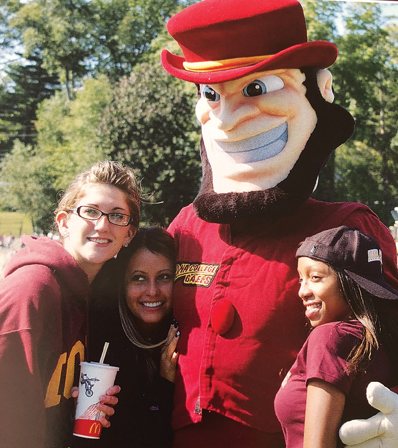 Women smile and pose with Killian the Gael.