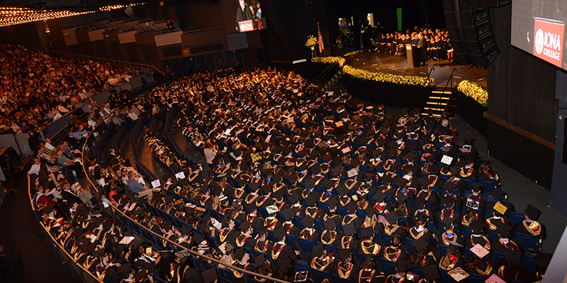 Bird's eye view of graduates facing the stage in Madison Square Garden.