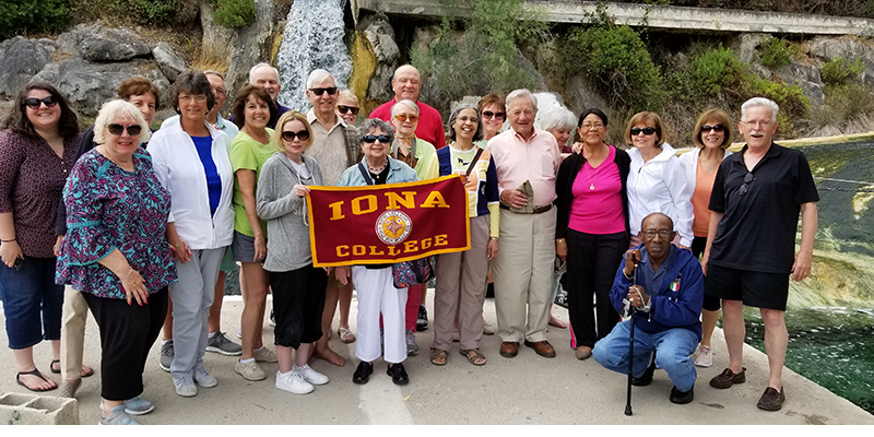 Alumni holding an Iona College banner in Greece.