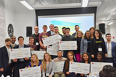 Winners display their checks.