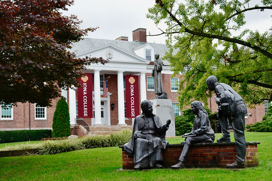 Three statues on the Iona College campus with the new banners in the background.