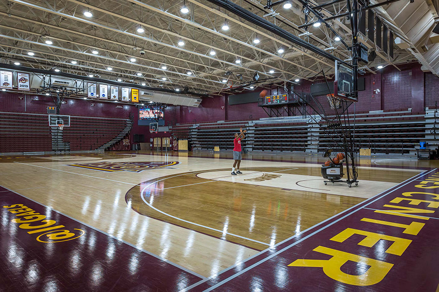 A basketball player practices his jump shot in the renovated gym.