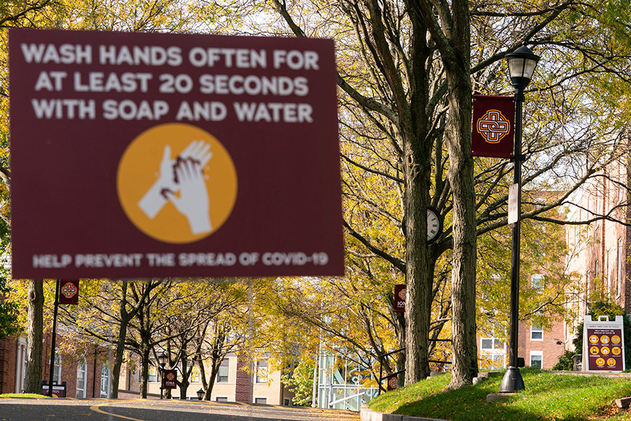 A sign on campus reminds people to wash hands with soap and water for at least 20 seconds.