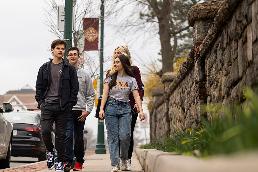 Four Iona students walk down North Avenue.