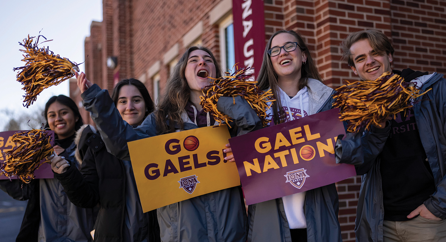 Gael Guides welcome guests onto campus with cheers and pom poms