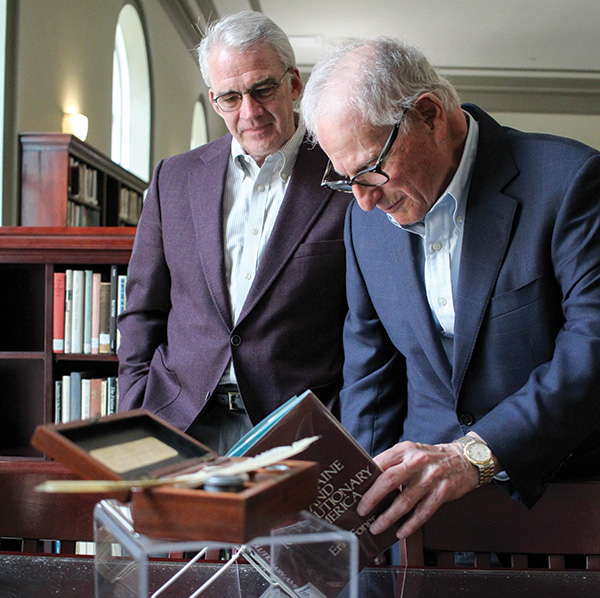 President Seamus Carey and Sid Lapidus view Thomas Paine memorabilia on display.