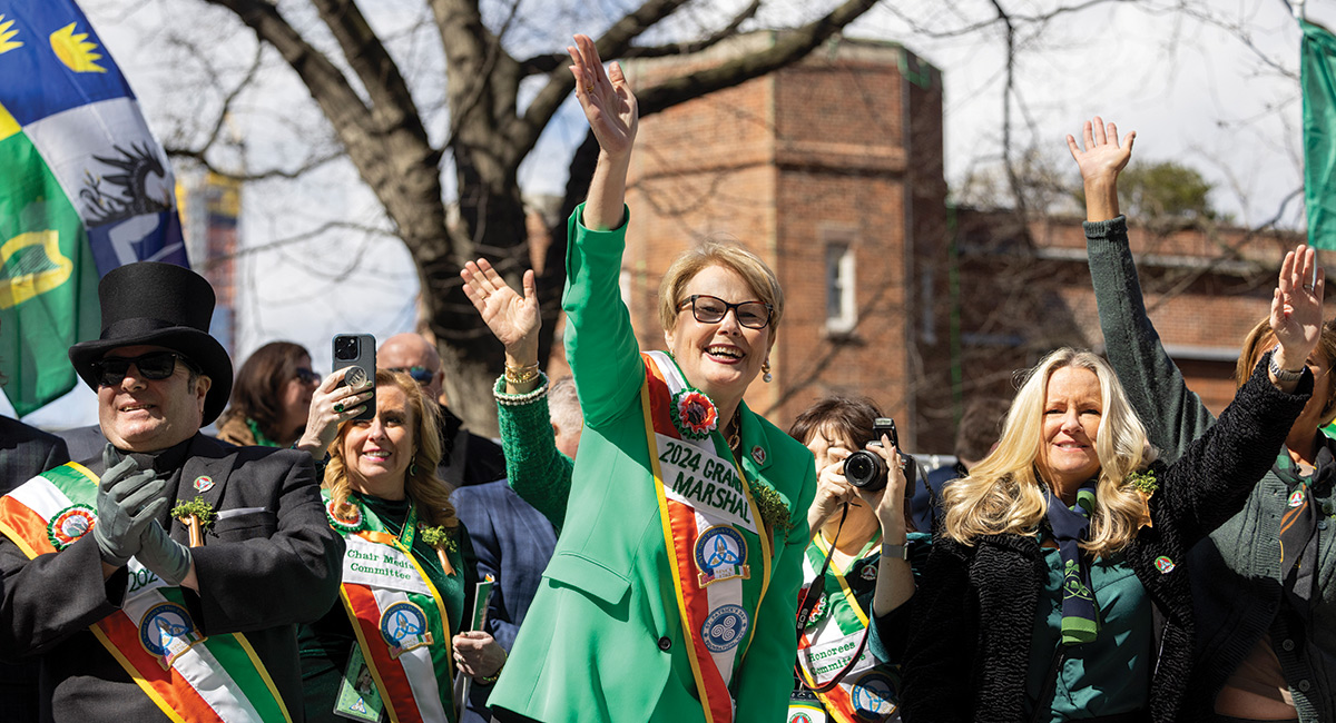 Maggie Timoney ’89, ’92MBA, ’23H, CEO of HEINEKEN® USA, waves to the crowd as grand marshal.